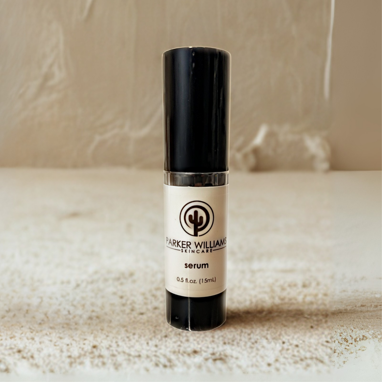 Skincare bottle labeled 'Parker Williams Serum' on a textured surface with neutral background