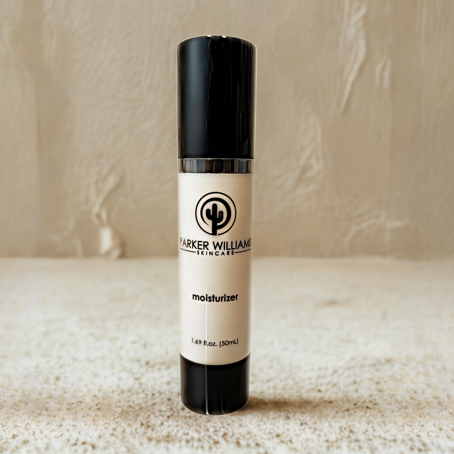 Skincare bottle labeled 'Parker Williams Moisturizer' on a textured surface with neutral background