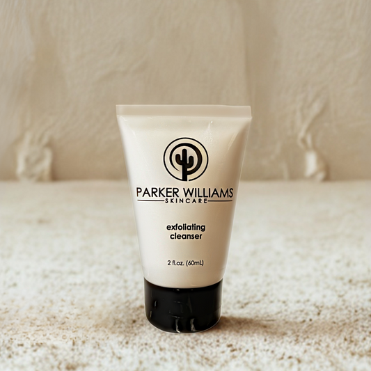 Tube of Parker Williams Skincare exfoliating cleanser on a textured surface