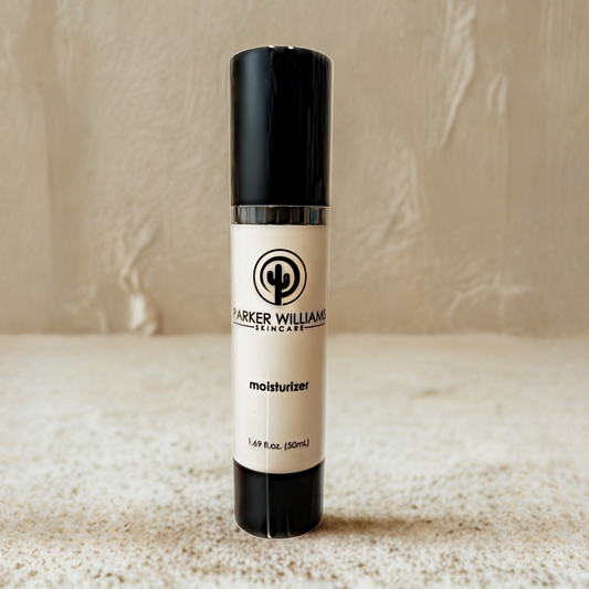 Skincare bottle labeled 'Parker Williams Moisturizer' on a textured surface with neutral background